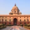 Explore the iconic Rashtrapati Bhavan with its historical architecture in sunny Delhi.
